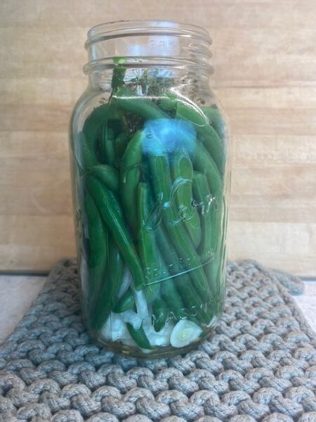 green beans stuffed into a jar