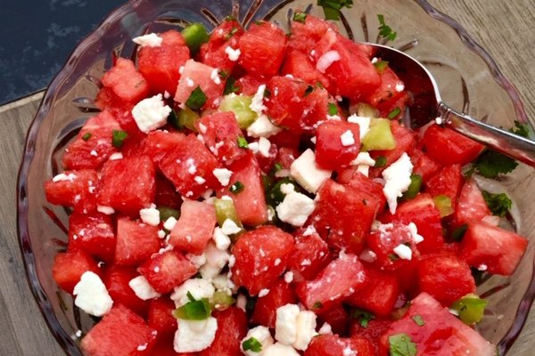 Watermelon Salsa with feta cheese in a clear bowl.