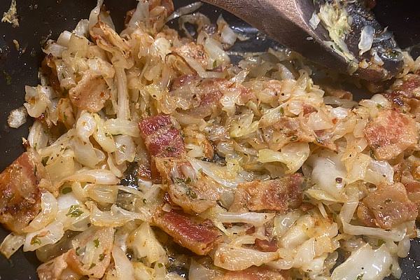 frying bacon with onions and cabbage