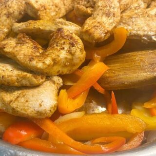 chcicken and peppers in skillet