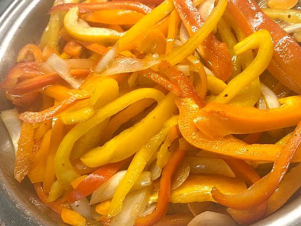 peppers and onion in the skillet