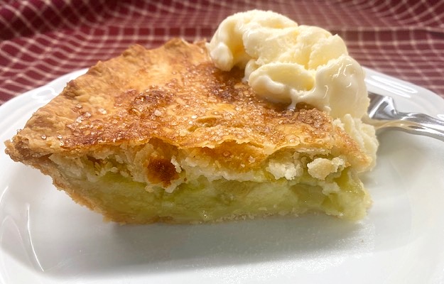 a slice of rhubarb custard pie on a white plate