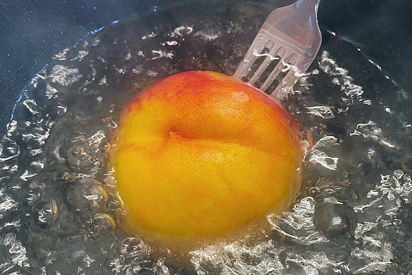 peach in boiling water