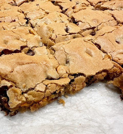 butterscotch brownies on parchment, cut into bars
