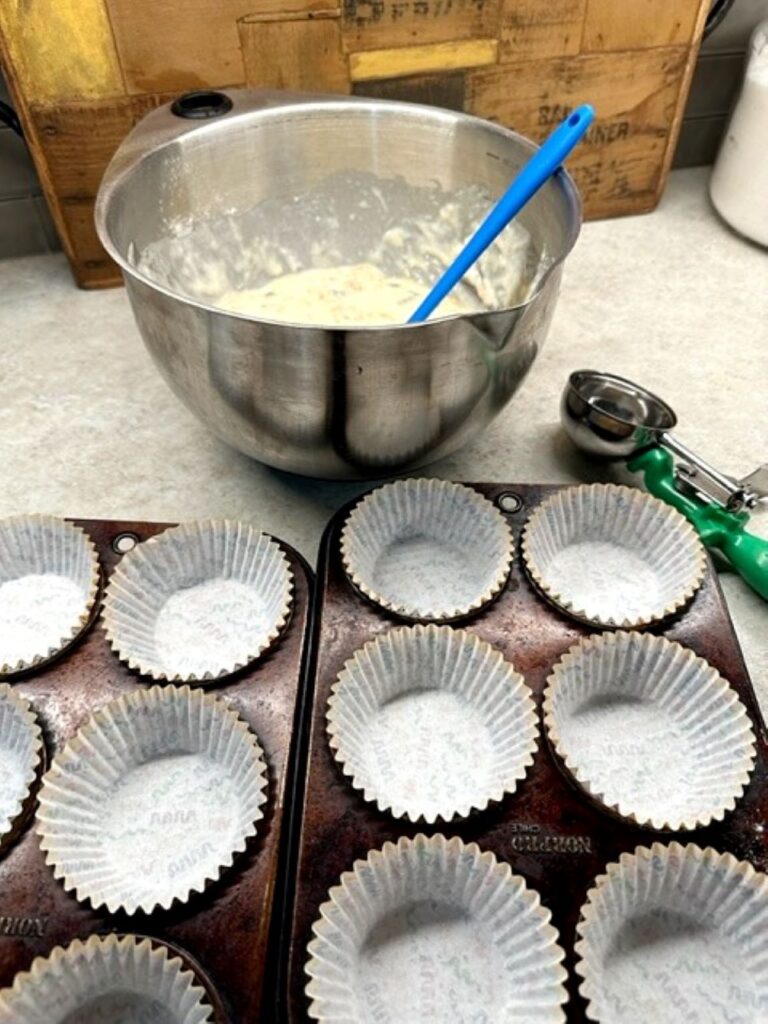 ready to scoop raisin bran muffins batter into baking cups
